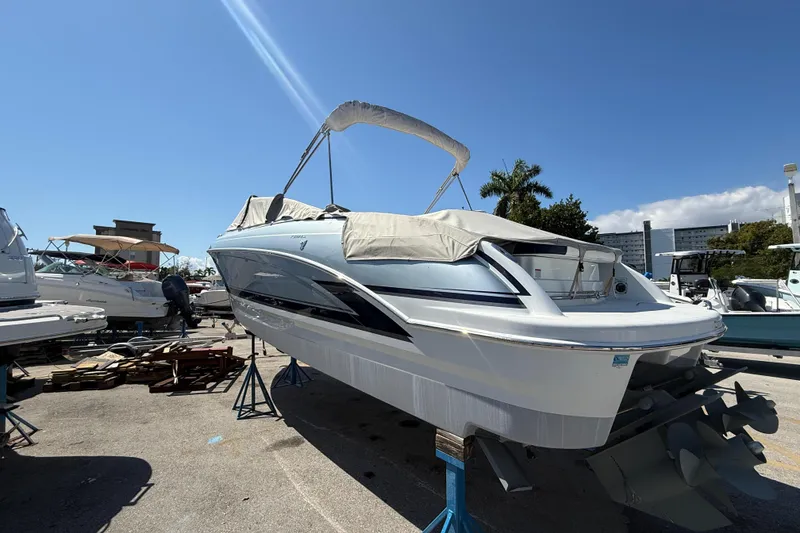 Slide: The Image of 2014 Formula 290 Sun Sport boat on stands, under clear blue sky. - 4