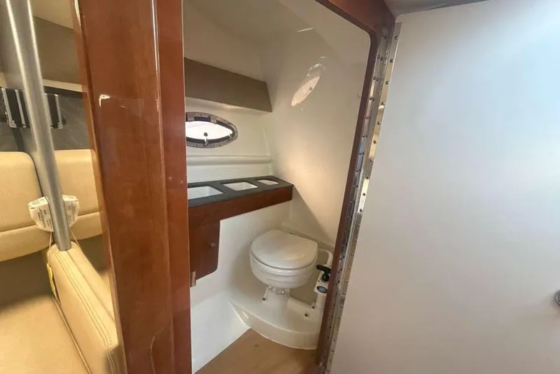 Slide: The Image of 2014 Formula 290 Sun Sport boat bathroom with wooden accents and compact design. - 41