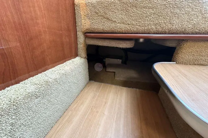 Slide: The Image of Interior view of 2014 Formula 290 Sun Sport boat, featuring carpeted flooring and wooden accents. - 46