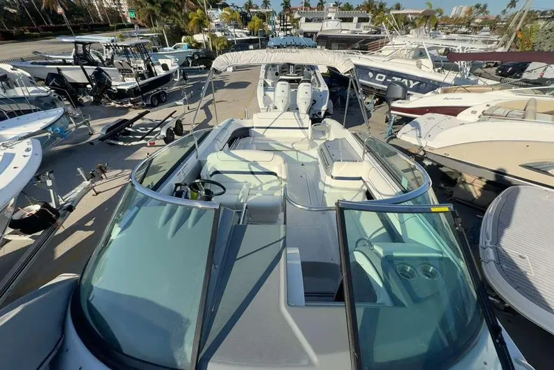 Slide: The Image of 2014 Formula 290 Sun Sport boat docked among other vessels in a marina. - 49