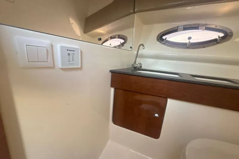 Slide: The Image of 2014 Formula 290 Sun Sport cabin interior with sink and porthole window. - 50