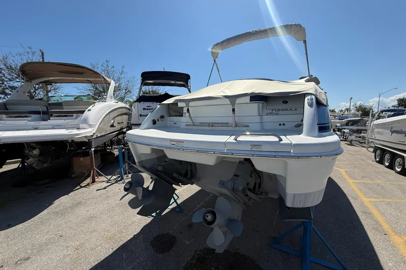 Slide: The Image of 2014 Formula 290 Sun Sport boat on display in a marina under clear blue sky. - 6