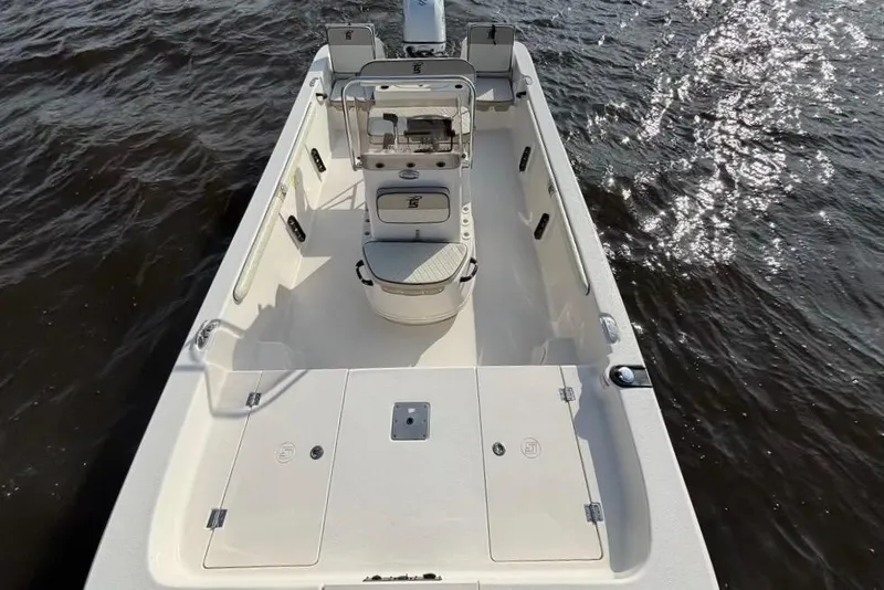 Slide: The Image of 2022 Carolina Skiff 19 LS boat on water, showcasing spacious deck and seating. - 11