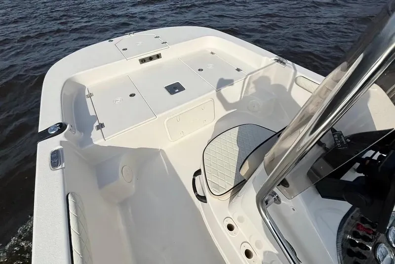 Slide: The Image of 2022 Carolina Skiff 19 LS boat interior with storage compartments on the water. - 12