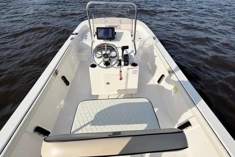 Slide: The Image of 2022 Carolina Skiff 19 LS boat interior with steering console on open water. - 13