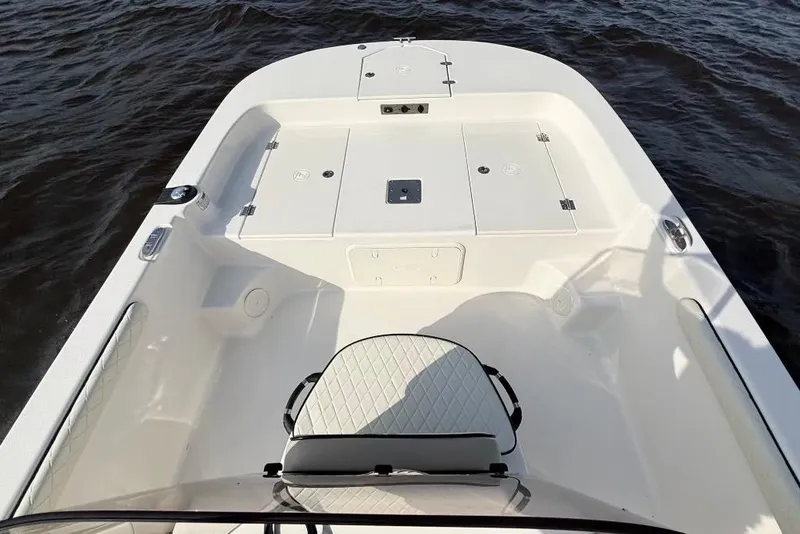 Slide: The Image of 2022 Carolina Skiff 19 LS boat interior with seating and storage, on water. - 15