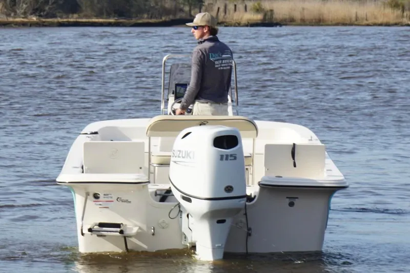 Slide: The Image of 2022 Carolina Skiff 19 LS boat with Suzuki 115 engine on a calm river. - 3