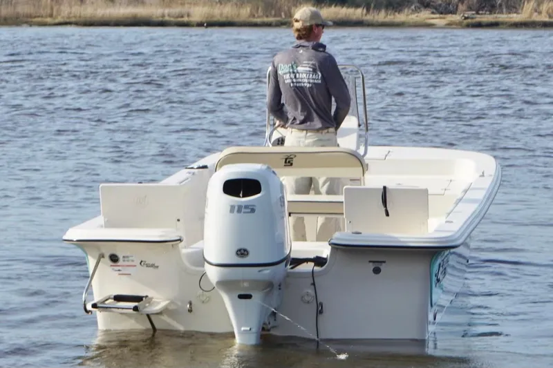 Slide: The Image of 2022 Carolina Skiff 19 LS boat on water, rear view with outboard motor. - 5