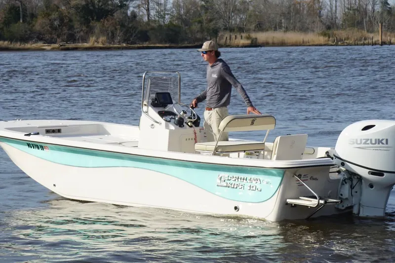 Slide: The Image of 2022 Carolina Skiff 19 LS boat on water with Suzuki outboard motor. - 6