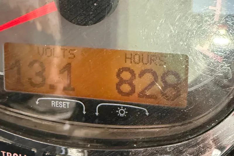 Slide: The Image of Close-up of a 2005 Renegade 29CC gauge showing 13.1 volts and 828 hours. - 10