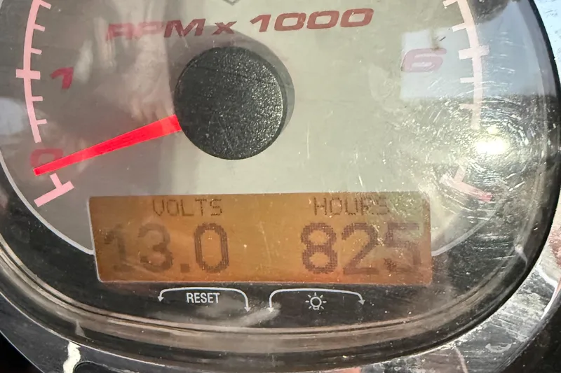 Slide: The Image of Close-up of a 2005 Renegade 29CC gauge showing 13 volts and 825 hours. - 11