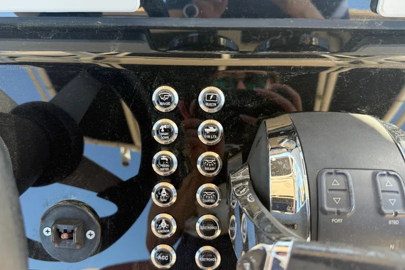 Slide: The Image of Control panel of a 2005 Renegade 29CC boat with labeled buttons and switches. - 12