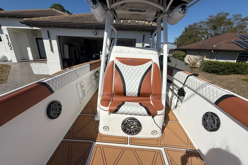 Slide: The Image of 2005 Renegade 29CC boat interior with brown and white seating, speakers, and deck. - 21