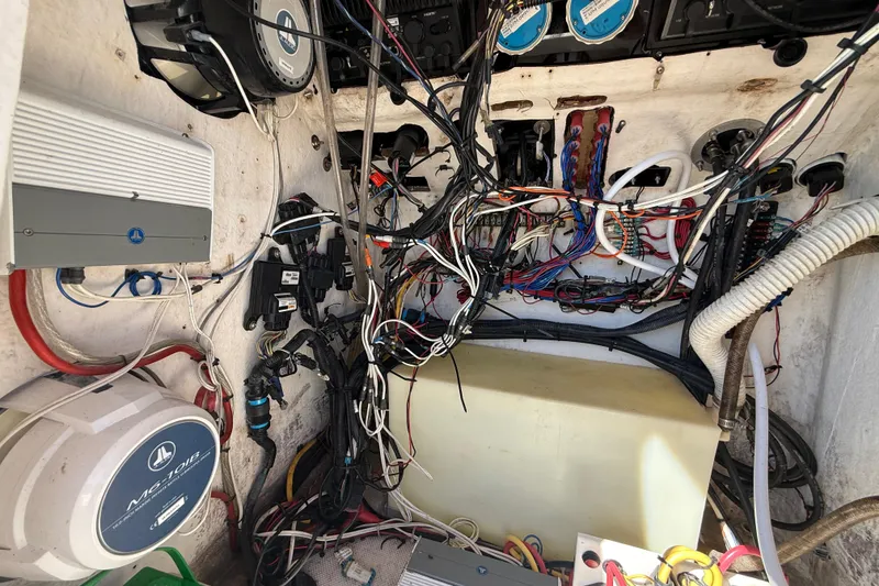 Slide: The Image of 2005 Renegade 29CC boat wiring and electronics setup with various cables and components. - 24