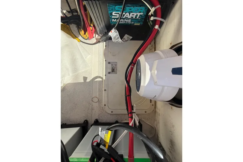 Slide: The Image of 2005 Renegade 29CC boat battery compartment with wiring and marine equipment. - 26
