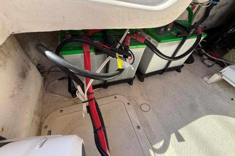 Slide: The Image of Battery compartment of a 2005 Renegade 29CC boat with connected cables. - 27