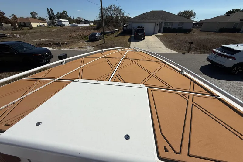 Slide: The Image of 2005 Renegade 29CC boat deck with tan non-slip surface in residential area. - 31
