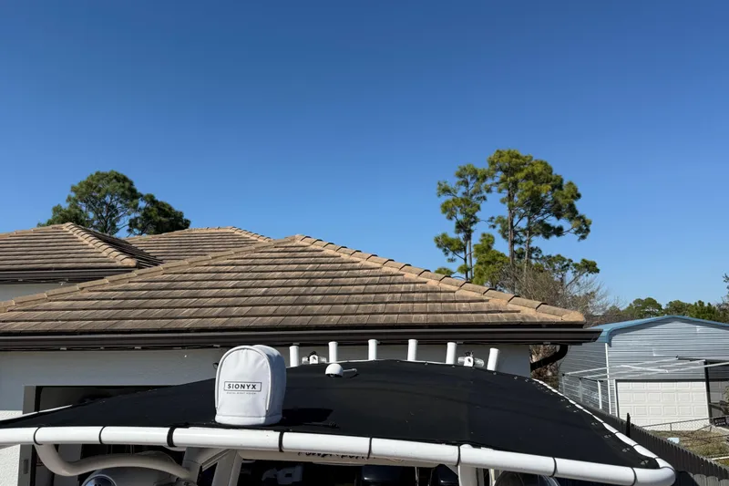 Slide: The Image of 2005 Renegade 29CC boat with Sionyx camera, house and trees in background. - 36