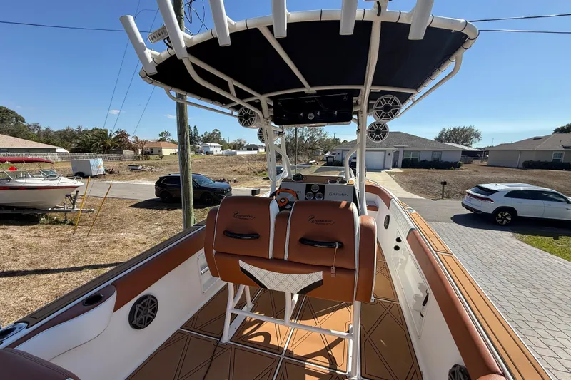 Slide: The Image of 2005 Renegade 29CC boat interior with brown seating and modern dashboard. - 5