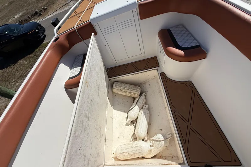 Slide: The Image of 2005 Renegade 29CC boat interior with storage compartment and seating. - 51