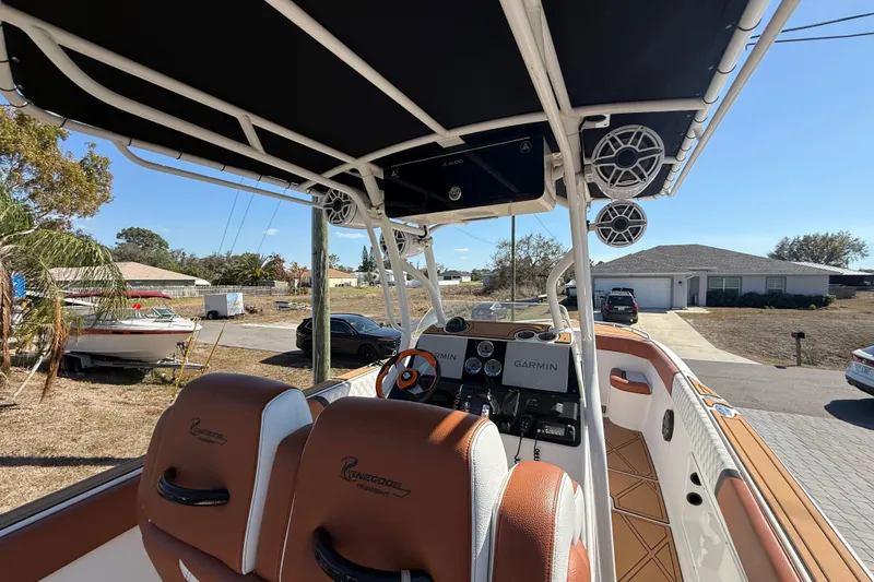 Slide: The Image of 2005 Renegade 29CC boat interior with Garmin navigation, parked in a residential area. - 6