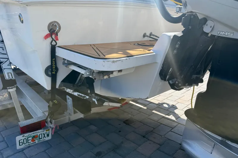 Slide: The Image of Rear view of a 2005 Renegade 29CC boat on a trailer, showing the motor and license plate. - 61