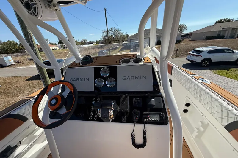 Slide: The Image of 2005 Renegade 29CC boat dashboard with Garmin navigation and steering wheel. - 7