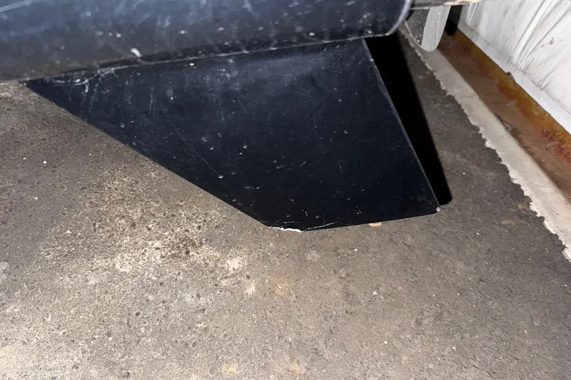 Slide: The Image of Close-up of a black fin on a 2023 Axopar 25 Cross Top boat. - 11