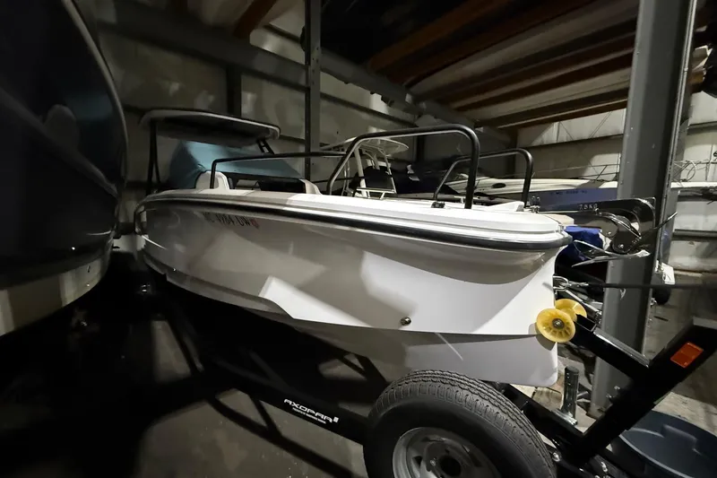 Slide: The Image of 2023 Axopar 25 Cross Top boat in storage, side view on trailer. - 12