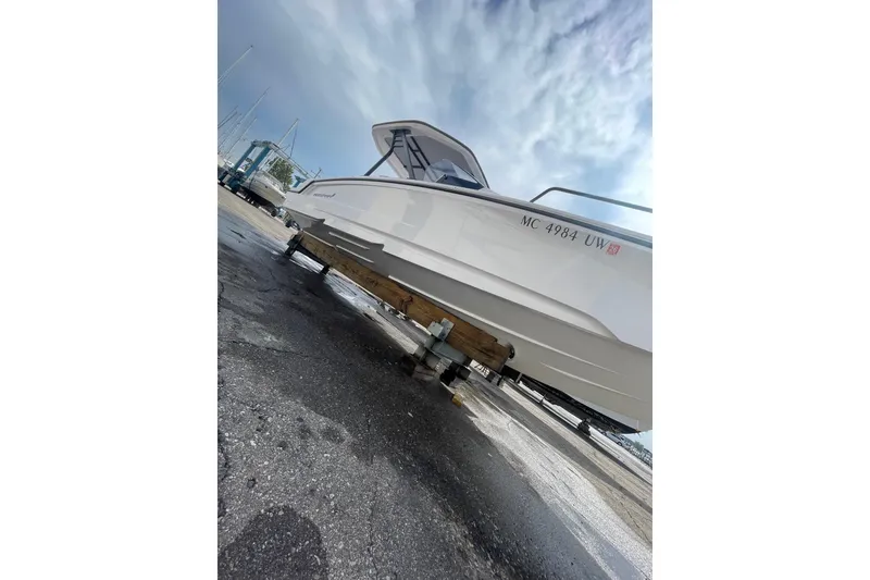 Slide: The Image of 2023 Axopar 25 Cross Top boat on a trailer, under a cloudy sky. - 15