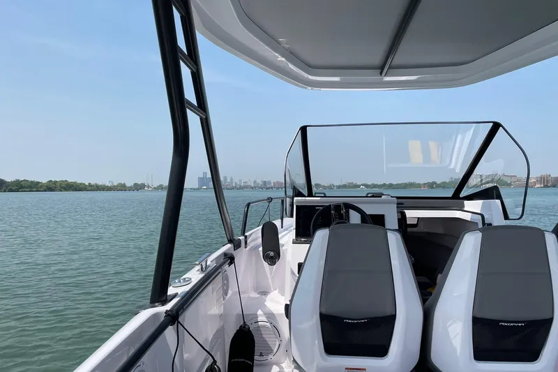 Slide: The Image of 2023 Axopar 25 Cross Top boat interior with city skyline view. - 5