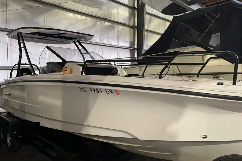 Slide: The Image of 2023 Axopar 25 Cross Top boat in storage, showcasing sleek design and modern features. - 7