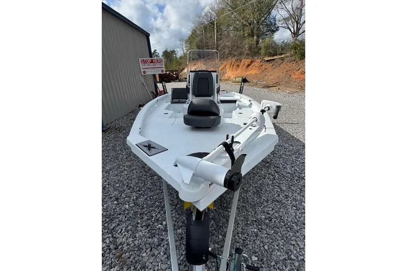 Slide: The Image of 2026 Xpress H20B Bay boat on gravel, featuring a sleek white design and modern seating. - 4