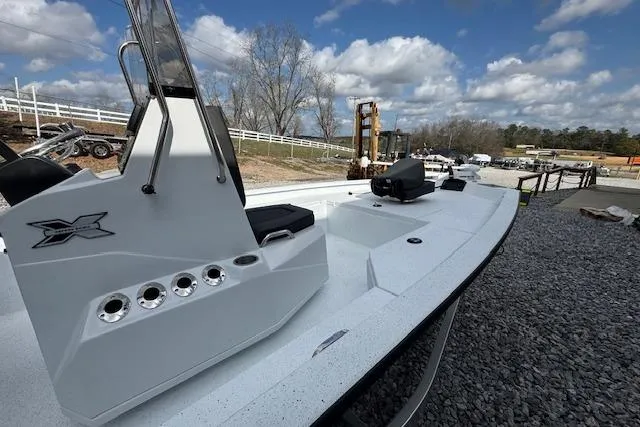 Slide: The Image of 2026 Xpress H20B Bay boat on gravel, showcasing sleek design and modern features. - 6