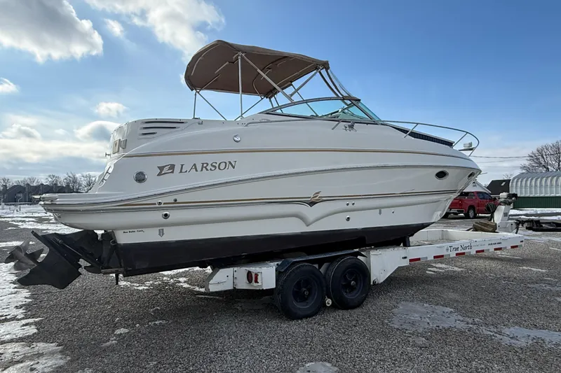 Slide: The Image of 2004 Larson 274 boat on trailer under blue sky, side view. - 20