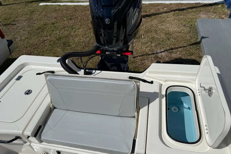 Slide: The Image of 2026 Skeeter SX221 boat interior with seating and open storage compartment. - 13