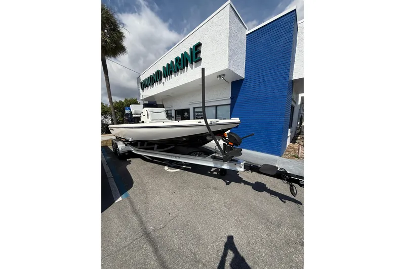 Slide: The Image of 2026 Skeeter SX221 boat on trailer outside marine store. - 16