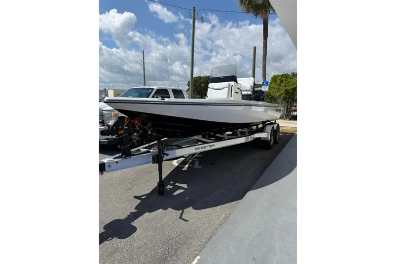 Slide: The Image of 2026 Skeeter SX221 boat on trailer under a clear blue sky. - 3