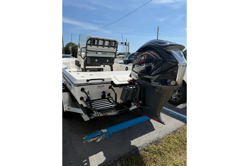 Slide: The Image of 2026 Skeeter SX221 boat with Yamaha outboard motor in a parking lot. - 4