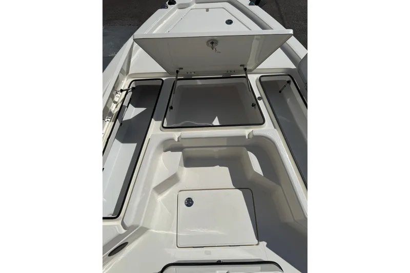 Slide: The Image of 2026 Skeeter SX221 boat storage compartments open, showcasing spacious interior design. - 7