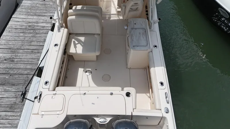 Slide: The Image of 2017 Grady-White Freedom 275 boat docked, showcasing spacious seating and deck layout. - 12