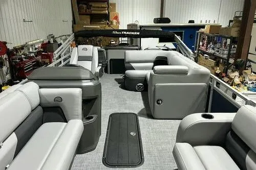 Slide: The Image of 2026 Sun Tracker SportFish 22 XP3 pontoon boat interior with gray seating and spacious layout. - 10