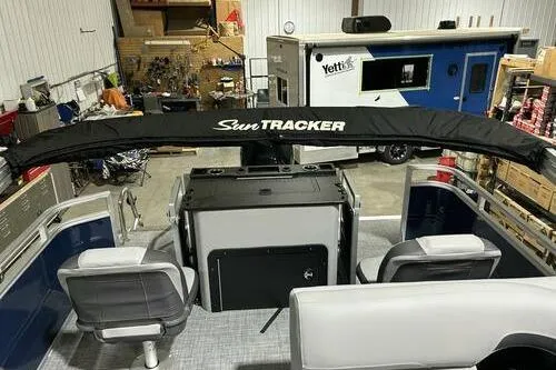 Slide: The Image of 2026 Sun Tracker SportFish 22 XP3 boat interior in a garage setting. - 11