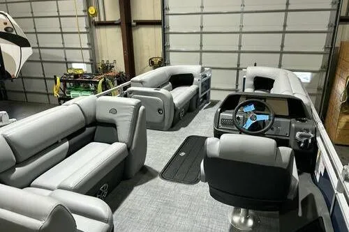 Slide: The Image of 2026 Sun Tracker SportFish 22 XP3 pontoon boat interior with plush seating and modern dashboard. - 5