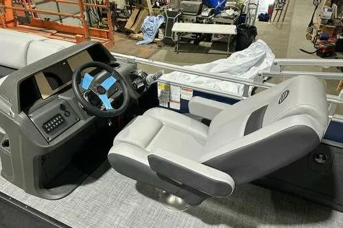 Slide: The Image of 2026 Sun Tracker SportFish 22 XP3 boat interior with steering console and captain's chair. - 7