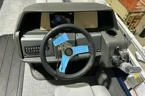 Slide: The Image of 2026 Sun Tracker SportFish 22 XP3 boat dashboard with steering wheel and controls. - 9