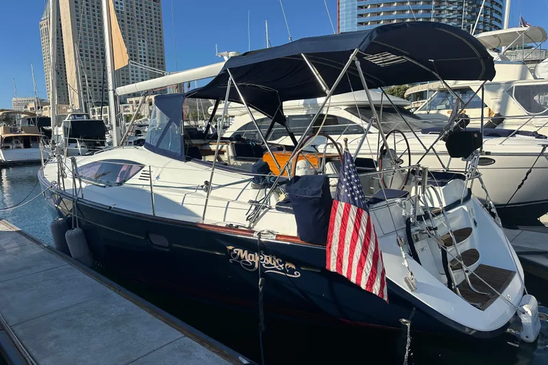 The Image of 2008 Jeanneau Sun Odyssey 45 DS sailboat docked at marina with American flag. - 0