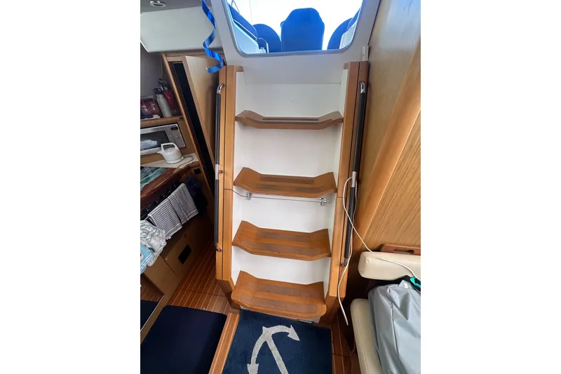 Slide: The Image of Interior of 2008 Jeanneau Sun Odyssey 45 DS sailboat with wooden stairs and nautical decor. - 12