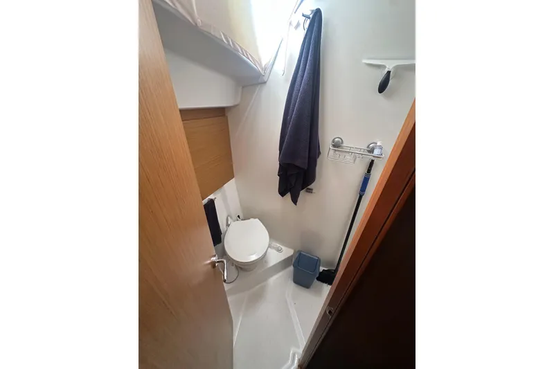 Slide: The Image of Compact bathroom in 2008 Jeanneau Sun Odyssey 45 DS sailboat, featuring toilet and storage. - 15