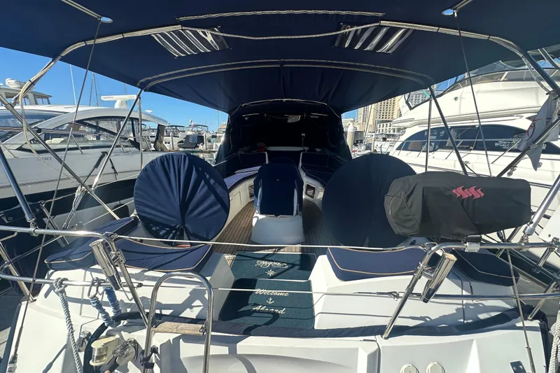 Slide: The Image of 2008 Jeanneau Sun Odyssey 45 DS sailboat with blue canopy, docked at marina. - 4